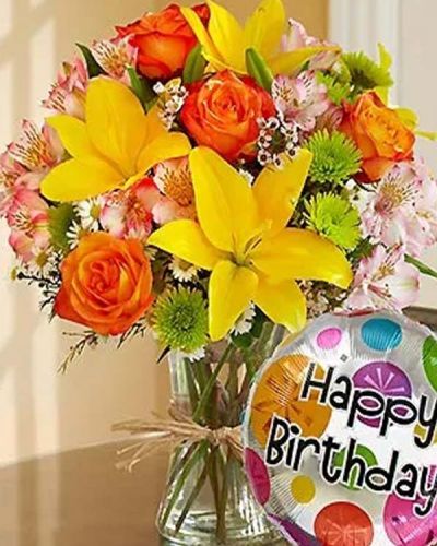 <p>Get their party started with this elegant, hand-designed bouquet! Fresh roses, lilies, alstroemeria, poms and more are arranged by our florists inside a stylish clear glass vase tied with raffia as a nod to rustic European style. Paired with a festive 18" Mylar balloon, this is a perfect way to say "Happy Birthday!"</p>