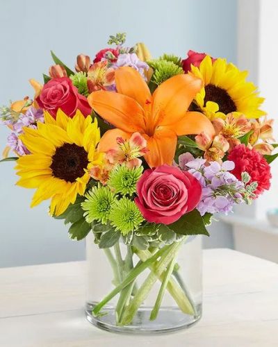 <p>Like a warm embrace, our vibrant flower bouquet delivers your sentiments to someone special. A rich gathering of yellow and orange blooms, with pops of bright pink and purple, it's more than a gift - it's a way to express how you feel inside.</p>