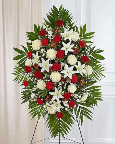 <p>A warm embrace. A kind word. A memorable gesture. There are many ways to express how we feel after the loss of a loved one. Our classic standing spray arrangement is elegantly crafted with radiant red roses and peaceful white blooms, offering care and support when it’s needed most.</p>
<ul>
<li>One-sided standing spray arrangement with red roses, carnations and hypericum, white Asiatic lilies, football mums, stock and monte casino; accented with assorted greenery</li>
<li>Extra large arrangement measures approximately 60"H x 40"W without stand</li>
<li>Large arrangement measures approximately 56"H x 38"W without stand</li>
<li>Medium measures approximately 46"H x 34"W without stand</li>
<li>Small measures approximately 42"H x 30"W without stand</li>
<li>Arrives on an easel</li>
<li>Appropriate for the funeral home or gravesite</li>
<li>Our florists hand-design every arrangement, so colors and varieties may vary due to local availability</li>
</ul>