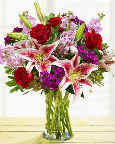 Enjoy this exquisite combination of red and purple bloom guaranteed to make your recipient equally dazzled with the unparalleled beauty of this arrangement. Whether it's for a special occasion or just because, it's a gift that you'll be glad you sent.