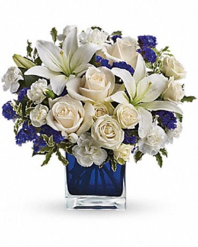 <div class="m-pdp-tabs-description">
<div id="mark-1" class="m-pdp-tabs-marketing-description">Send someone a bit of heaven with this beautiful bouquet. Luxurious crème roses and pure white lilies paint a peaceful picture inside a blue cube.</div>
</div>
<p id="arrngDescp">Crème roses, white asiatic lilies and white miniature carnations are mixed with bursts of purple statice and green pitta negra. Delivered in a glass cube.</p>
