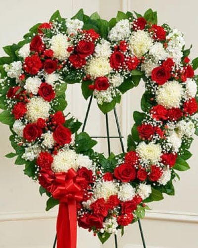 <p>It's not always easy to express your feelings when someone you love has passed on. With this floral tribute, your deepest condolences and undying love are clearly on display. Our expert florists craft red and white roses, football mums, carnations and more into an exquisite open-heart arrangement to help you convey your sympathies. Traditionally sent directly to the funeral home by family members or friends and displayed on a stand.</p>