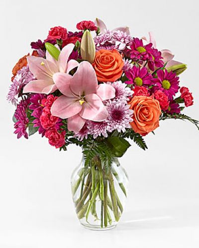 <p>The Light of My Life Bouquet blossoms with brilliant color and a sweet sophistication to create the perfect impression! Pink Lilies make the eyes dance across the unique design of this flower bouquet, surrounded by the blushing colors of orange roses, lavender cushion poms, hot pink carnations, and lush greens. Presented in a clear glass vase, this fresh flower arrangement has been created just for you to help you send your sweetest thank you, happy anniversary, or thinking of you wishes.</p>